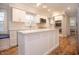 Modern kitchen boasts white cabinets, stainless steel appliances, and center island at 13948 Silver Stream Dr, Carmel, IN 46032