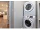 Convenient laundry area with stacked washer and dryer, offering space-saving efficiency for modern living at 13948 Silver Stream Dr, Carmel, IN 46032