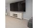 Entertainment area with a large TV, white cabinet, and a guitar on display, perfect for entertainment at 13948 Silver Stream Dr, Carmel, IN 46032