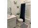 A clean bathroom featuring vanity, toilet, shower with curtain, and modern decor at 142 Winding Brook Way, Pendleton, IN 46064
