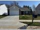 Charming single-story home with a well-manicured front yard and a two car garage at 142 Winding Brook Way, Pendleton, IN 46064