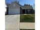 Charming single-story home with a well-manicured front yard and a two car garage at 142 Winding Brook Way, Pendleton, IN 46064