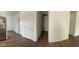 An empty hallway with multiple doors and wood flooring, connecting the rooms of the house at 142 Winding Brook Way, Pendleton, IN 46064