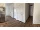 An empty hallway with multiple doors and wood flooring, connecting the rooms of the house at 142 Winding Brook Way, Pendleton, IN 46064