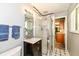Well-lit bathroom with mosaic tile accent, modern vanity, and glass-enclosed shower at 143 Beechview Ln, Indianapolis, IN 46217