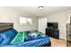 Comfortable bedroom with a blue Notre Dame comforter, dresser, and a flat screen TV at 143 Beechview Ln, Indianapolis, IN 46217