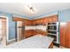 Spacious kitchen boasting stainless steel appliances, an island, granite counters, and warm wood cabinetry at 143 Beechview Ln, Indianapolis, IN 46217