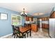 Open kitchen features a dining area, stainless steel appliances, and stylish countertops at 143 Beechview Ln, Indianapolis, IN 46217