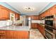 Well-equipped kitchen with stainless steel appliances, granite countertops, and custom wood cabinets at 143 Beechview Ln, Indianapolis, IN 46217