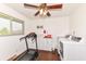 Bright laundry room equipped with modern washer and dryer, treadmill and ample storage at 143 Beechview Ln, Indianapolis, IN 46217