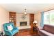 Inviting living room features a cozy fireplace, built-in bookshelves, and bright natural light at 143 Beechview Ln, Indianapolis, IN 46217