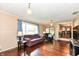 Bright living room with hardwood floors, large window, and view into the dining area at 143 Beechview Ln, Indianapolis, IN 46217