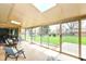 Inviting sunroom with multiple seating areas and a beautiful view of the landscaped backyard at 143 Beechview Ln, Indianapolis, IN 46217