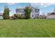 Expansive backyard featuring a green lawn, established trees, and manicured shrubs at 14323 Chariots Whisper Dr, Carmel, IN 46074