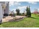 Lush backyard with a well-manicured lawn, mature trees, and landscaped garden beds at 14323 Chariots Whisper Dr, Carmel, IN 46074