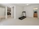 Basement featuring neutral carpet, exercise equipment, and easy access to rooms for convenience at 14323 Chariots Whisper Dr, Carmel, IN 46074