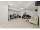 Basement featuring neutral carpet, media center, office space, and comfortable seating for a relaxing area at 14323 Chariots Whisper Dr, Carmel, IN 46074