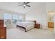Spacious bedroom with vaulted ceiling, carpet, ceiling fan and multiple windows at 14323 Chariots Whisper Dr, Carmel, IN 46074