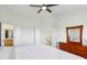 Bright bedroom featuring a large bed, a ceiling fan, and a wooden dresser with a mirror at 14323 Chariots Whisper Dr, Carmel, IN 46074