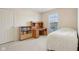 Neutral bedroom with a desk and bookshelf, a bed, a window and carpet at 14323 Chariots Whisper Dr, Carmel, IN 46074