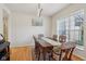 Traditional dining room with hardwood floors, bright natural light, and a decorative chandelier at 14323 Chariots Whisper Dr, Carmel, IN 46074