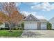 Charming two-story home with three-car garage and well-maintained front yard at 14323 Chariots Whisper Dr, Carmel, IN 46074