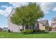 Well-maintained yard and gray two-story home with brick accents and lush landscaping at 14323 Chariots Whisper Dr, Carmel, IN 46074