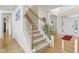 Inviting foyer with hardwood floors, staircase and natural light at 14323 Chariots Whisper Dr, Carmel, IN 46074