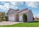 Spacious three-car garage with gray vinyl siding and brick accents at 14323 Chariots Whisper Dr, Carmel, IN 46074