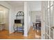 Bright hallway view with wood floors, showcasing an open dining area and access to another room at 14323 Chariots Whisper Dr, Carmel, IN 46074
