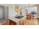 Open kitchen featuring a center island cooktop and seamless transition to the dining area at 14323 Chariots Whisper Dr, Carmel, IN 46074