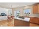 Eat-in kitchen featuring a center island with cooktop and view of the backyard through sliding glass doors at 14323 Chariots Whisper Dr, Carmel, IN 46074