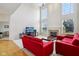 Bright living room featuring high ceilings, a fireplace, and natural light at 14323 Chariots Whisper Dr, Carmel, IN 46074