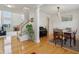 Open-concept living space showcasing hardwood floors, a fireplace, and an adjacent dining area at 14323 Chariots Whisper Dr, Carmel, IN 46074