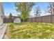 Backyard with lush grass, storage shed, and fenced perimeter at 15 N Campbell Ave, Indianapolis, IN 46219