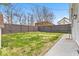 Large backyard with privacy fence, green grass and concrete patio at 15 N Campbell Ave, Indianapolis, IN 46219