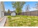 Backyard with lush grass, storage shed, and fenced perimeter at 15 N Campbell Ave, Indianapolis, IN 46219
