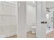 View through open door reveals a toilet, walk-in closet, and shower with glass enclosure at 15 N Campbell Ave, Indianapolis, IN 46219