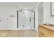 Glass shower enclosure and light hardwood flooring in a bathroom at 15 N Campbell Ave, Indianapolis, IN 46219