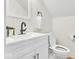 Elegant bathroom with a modern vanity, matte black faucet, and wainscoting at 15 N Campbell Ave, Indianapolis, IN 46219