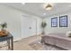 Bright bedroom featuring light hardwood floors, recessed lights, and a large window with black trim at 15 N Campbell Ave, Indianapolis, IN 46219