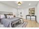 Spacious bedroom with light hardwood floors, recessed lights, and a side table on each side of the bed at 15 N Campbell Ave, Indianapolis, IN 46219