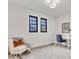 Neutral bedroom with chair, desk, and windows at 15 N Campbell Ave, Indianapolis, IN 46219