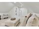 Bonus room featuring neutral carpeting, vaulted ceilings, bright white walls, and seating at 15 N Campbell Ave, Indianapolis, IN 46219