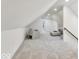 Bonus room features vaulted ceilings, neutral carpeting, bright white paint, and versatile design at 15 N Campbell Ave, Indianapolis, IN 46219
