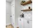 Coffee bar area featuring cabinets, countertop, shelves, decor, and hardwood floors at 15 N Campbell Ave, Indianapolis, IN 46219