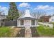 Charming home with a white exterior, black roof, brick chimney, and a welcoming front porch at 15 N Campbell Ave, Indianapolis, IN 46219