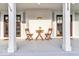 Inviting front porch features seating, dark wood doors, and a charming exterior at 15 N Campbell Ave, Indianapolis, IN 46219