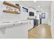 Bright kitchen with white cabinets, quartz countertops, and stainless steel appliances at 15 N Campbell Ave, Indianapolis, IN 46219