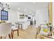 Open concept kitchen dining area with a breakfast bar and modern light fixtures at 15 N Campbell Ave, Indianapolis, IN 46219
